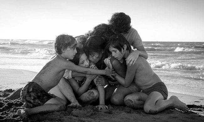 Characters hugging each other in the 2018 film Roma.
