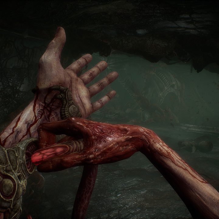 A character jabs a needle into their arm in Scorn.