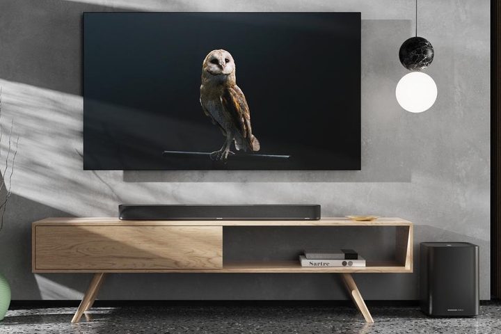 Sennheiser Ambeo Soundbar Plus with Ambeo Sub in front of a TV.