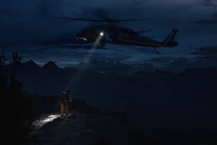 Search and rescue helicopter rescuing two stranded hikers.