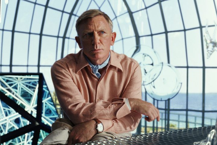 Daniel Craig stands and ponders in a scene from "Glass Onion: A Knives Out Mystery."