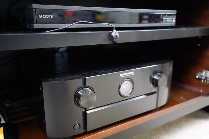 A Marantz A/V receiver and Sony 4K Blu-ray player controlled with an IR blaster from an Amazon Fire TV Omni QLED TV.