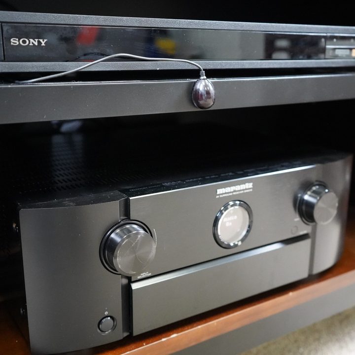 A Marantz A/V receiver and Sony 4K Blu-ray player controlled with an IR blaster from an Amazon Fire TV Omni QLED TV.