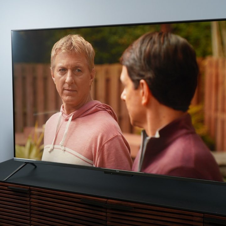 Amazon Fire TV Omni QLED with a scene from Netflix's Cobra Kai on-screen.