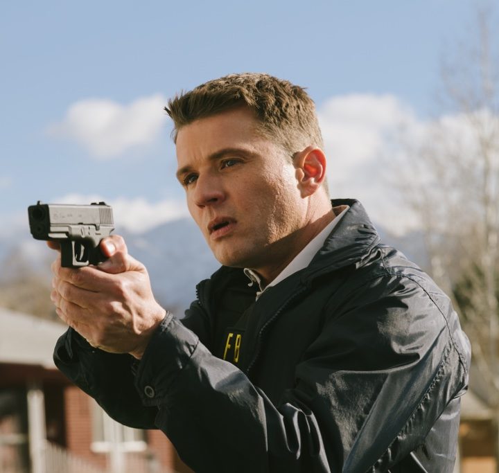Ryan Phillippe points a gun in a scene from American Murderer.