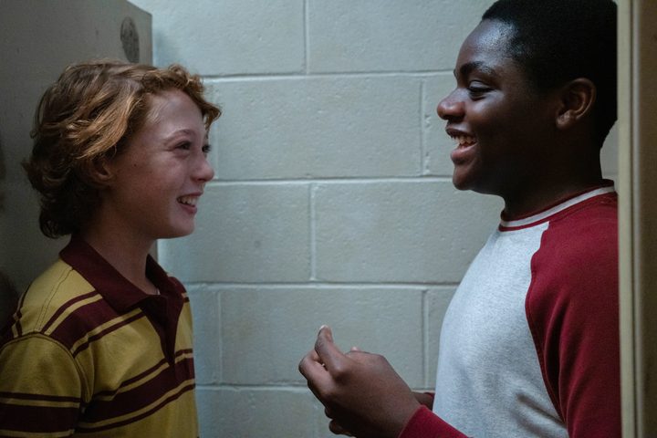Banks Repeta and Jaylin Webb laugh in a bathroom stall together in Armageddon Time.