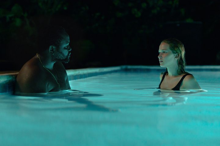 Brian Tyree Henry and Jennifer Lawrence look at each other in a pool in Causeway.