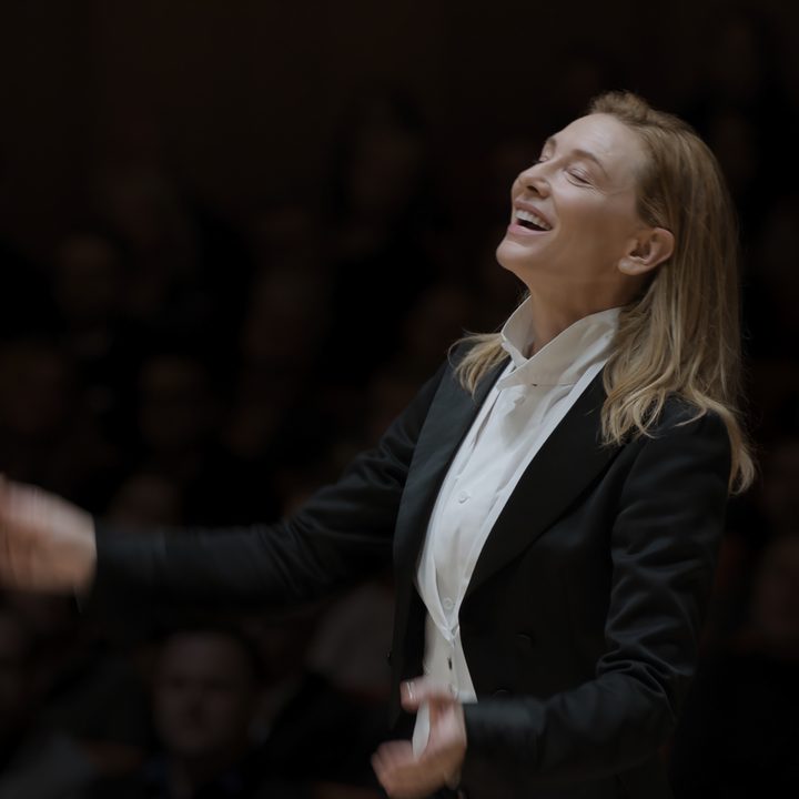 Cate Blanchett conducts music while wearing a suit in TÁR.