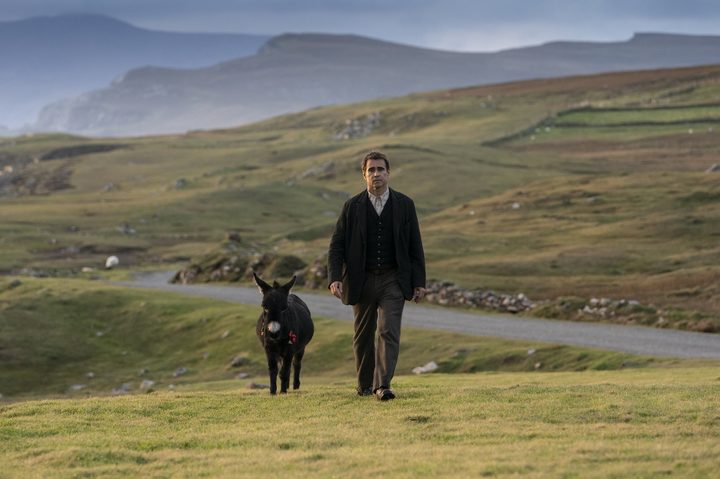 Colin Farrell walks next to a donkey in The Banshees of Inisherin.