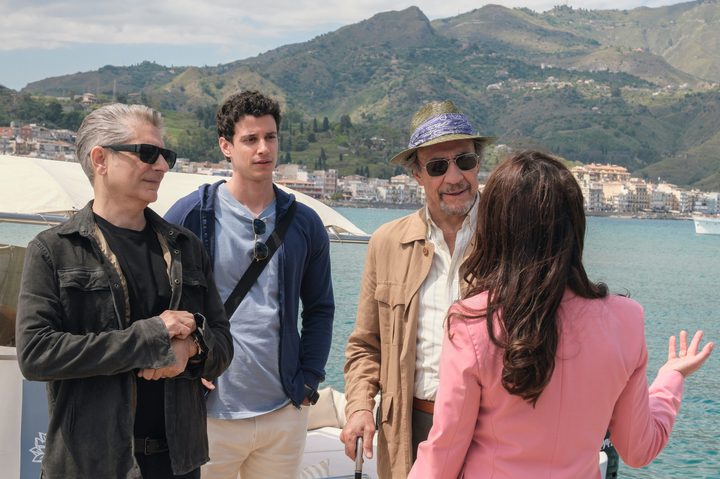 Dominic, Albie, and Bert stand by the sea together in The White Lotus Season 2.