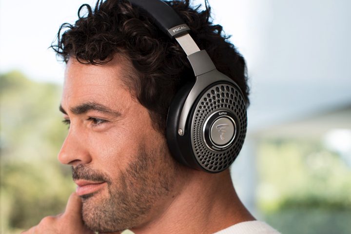 Man wearing Focal Bathys wireless headphones.
