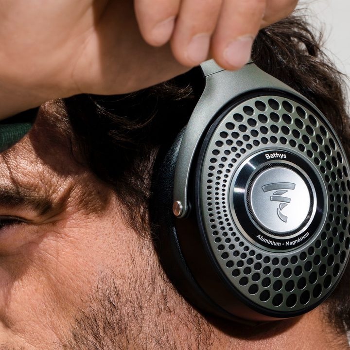 Close-up of man wearing Focal Bathys wireless headphones.