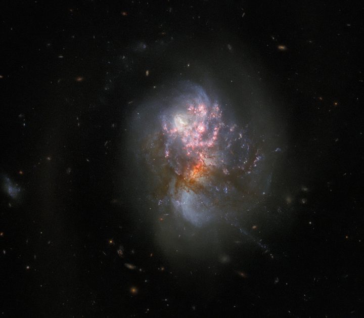 This image from the NASA/ESA Hubble Space Telescope depicts IC 1623. It combines data from Hubble’s ACS and WFC3 instruments, gives a familiar visible-light view of these colliding galaxies, where the centres of the individual galaxies are more obscured by dark dust.