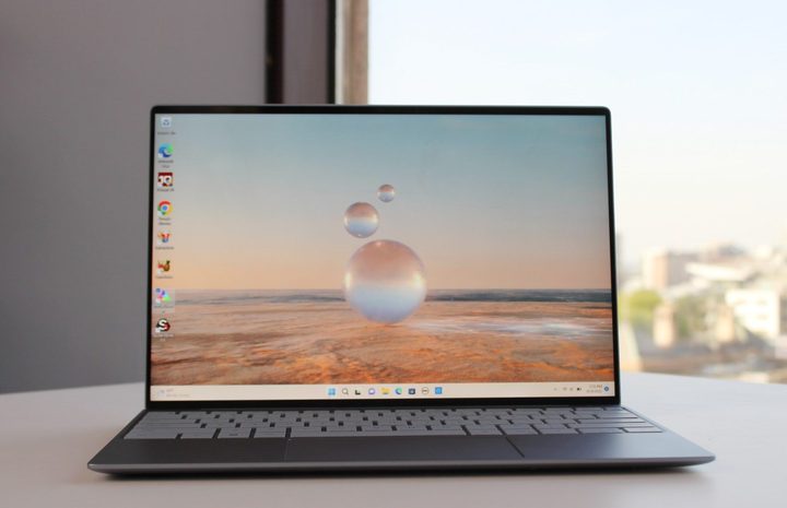 The Dell XPS 13 9315 on a table against a window.