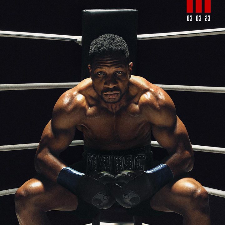 Jonathan Majors sits on a stool in a poster for Creed III.