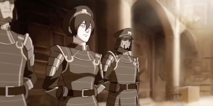 Toph stands next to police officers in The Legend of Korra.