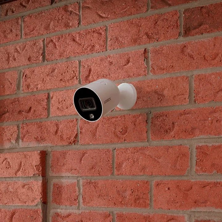Lorex smart 1080p Indoor Outdoor security camera mounted to brick wall.