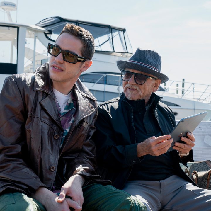 Pete Davidson and Joe Pesci sit down and chat in a scene from Bupkis.