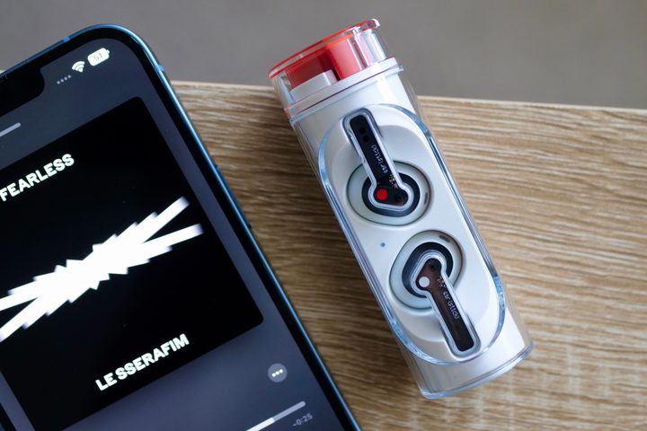 The Nothing Ear Stick's case alongside a smartphone.