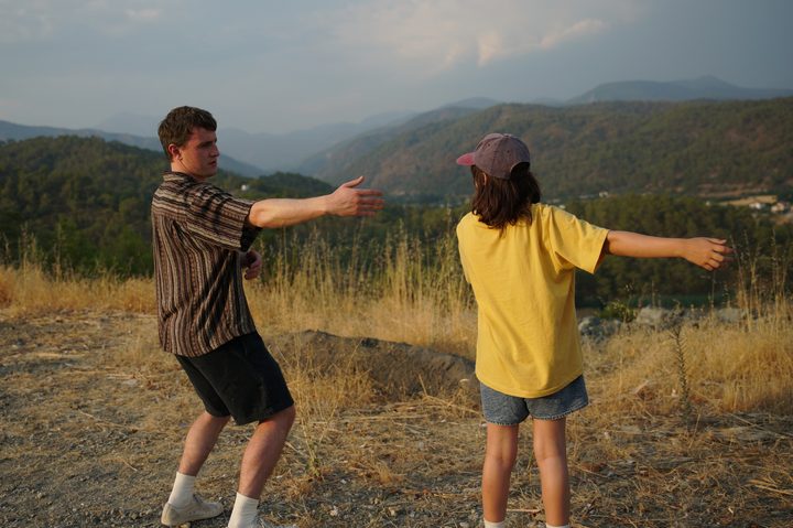 Paul Mescal and Frankie Corio pose outside together in A24's Aftersun.