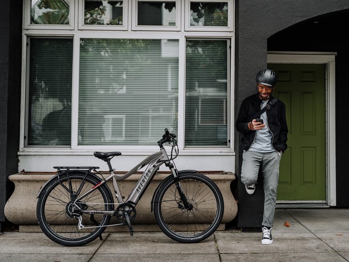 Rider commuting with Aventon Level.2 bike nearby.