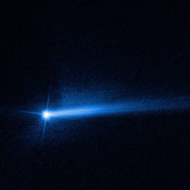 Two tails of dust ejected from the Didymos-Dimorphos asteroid system.