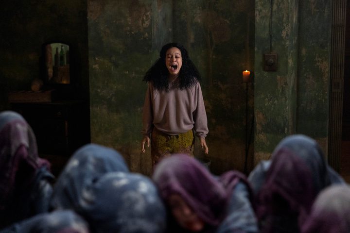 Sandra screams at a group of hooded figures in Netflix's The Midnight Club.