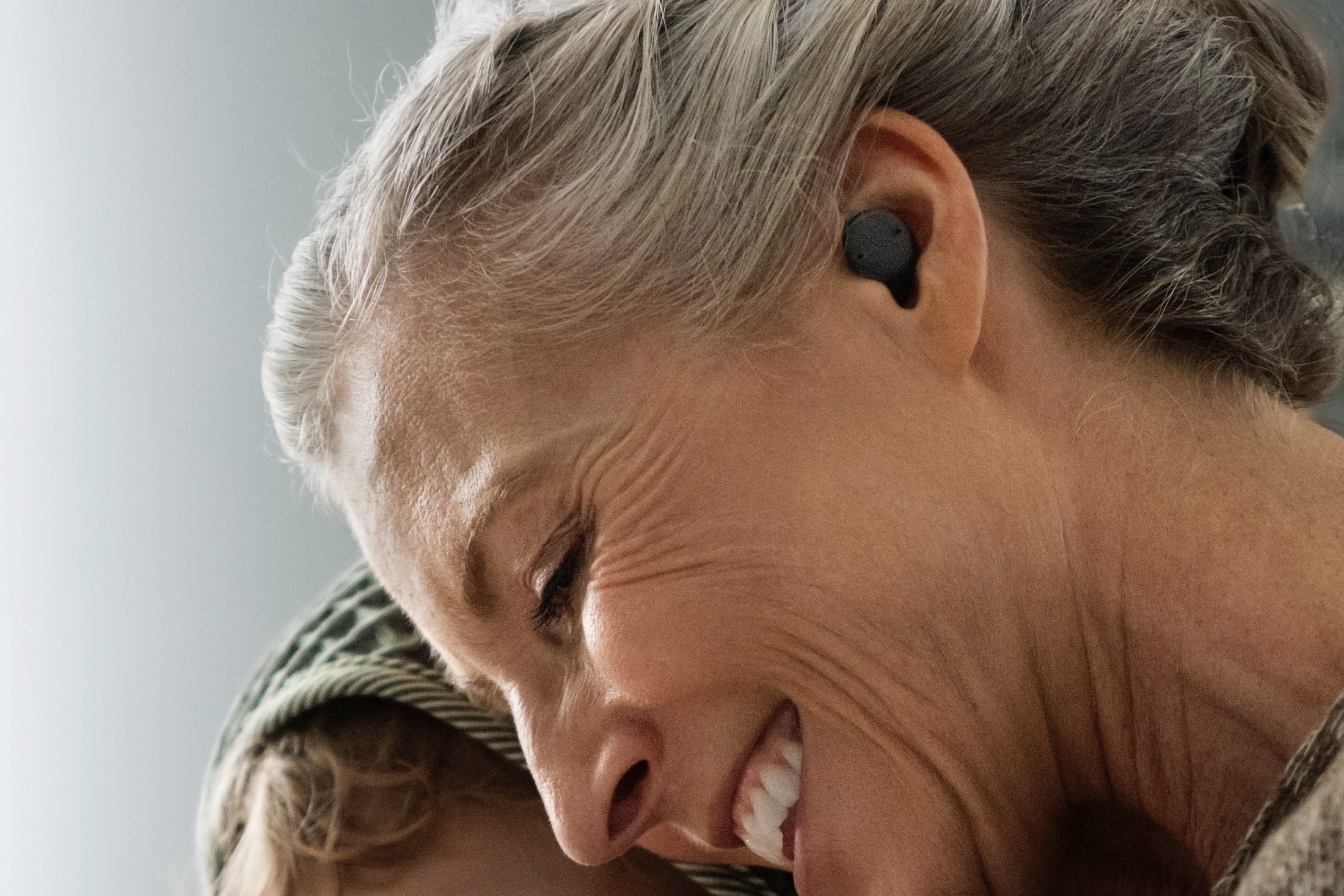 Woman wearing Sony CRE-E10 OTC hearing aids.