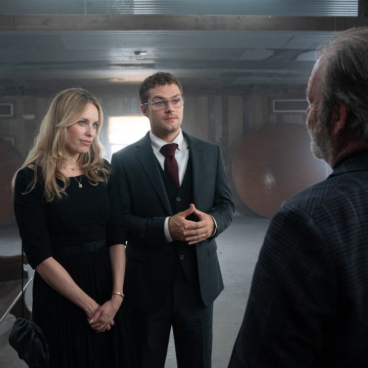Finn Jones and Jessica McNamee stand next to each other in a scene from The Vistor.