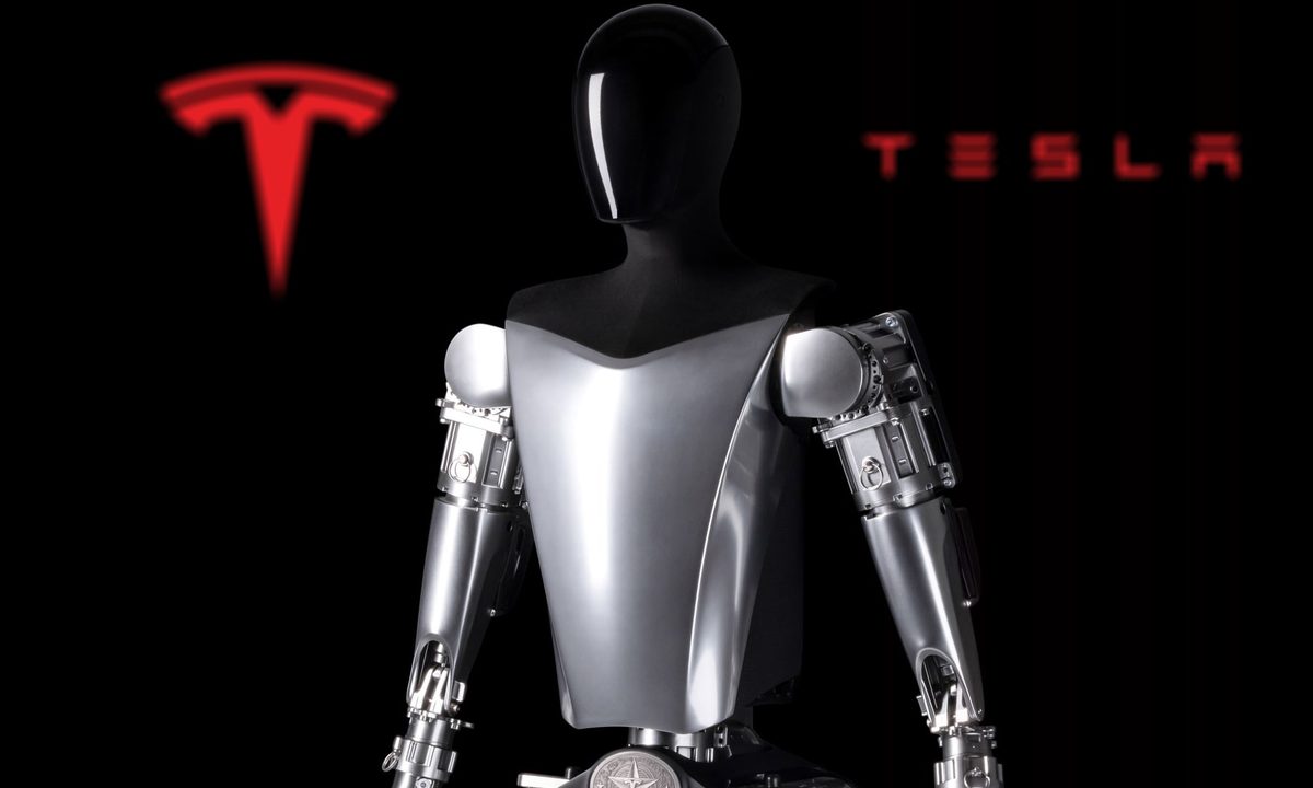 Tesla's 2022 Optimus robot prototype is seen in front of the company logo.