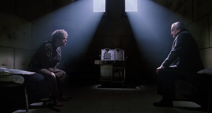 Kinderman and the Gemini Killer in a dark hospital room in "The Exorcist III."