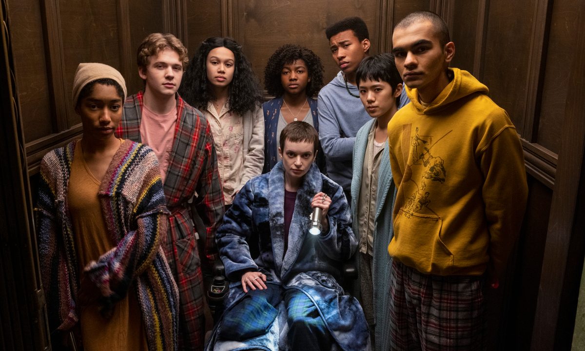 The members of The Midnight Club all stand in an elevator together.
