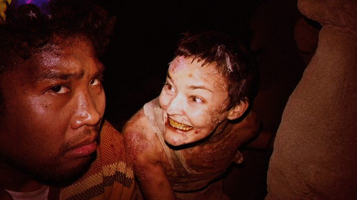 A demon smiles at a man in V/H/S/99.