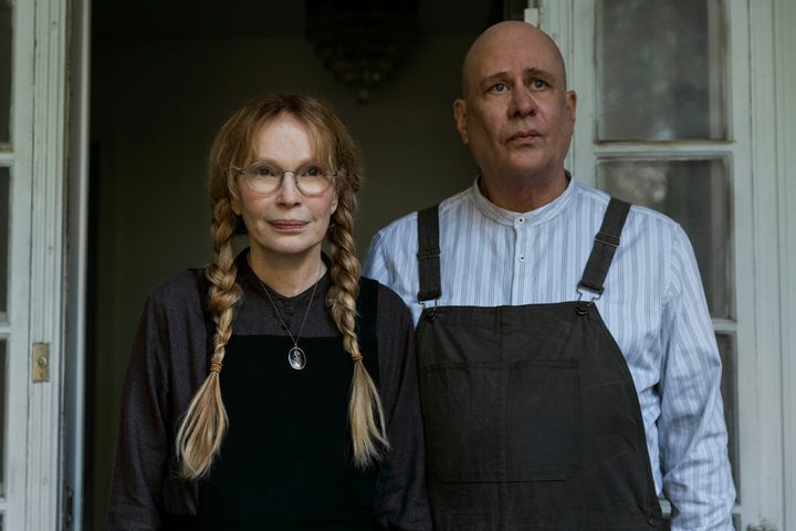 A man and a woman stand next to each other in The Watcher.