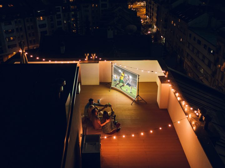 XGIMI Halo+ being watched on balcony for movie night.