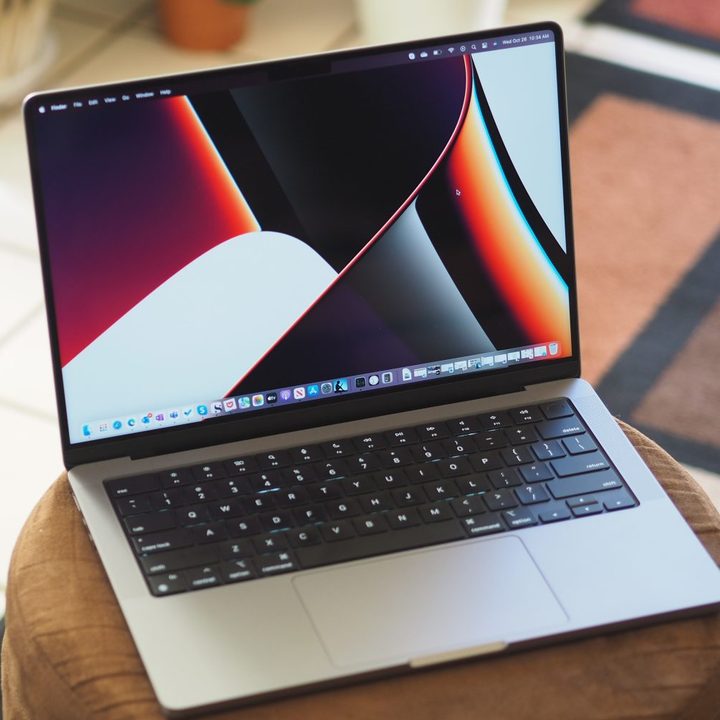 An Apple MacBook Pro 14 sits open on a table.