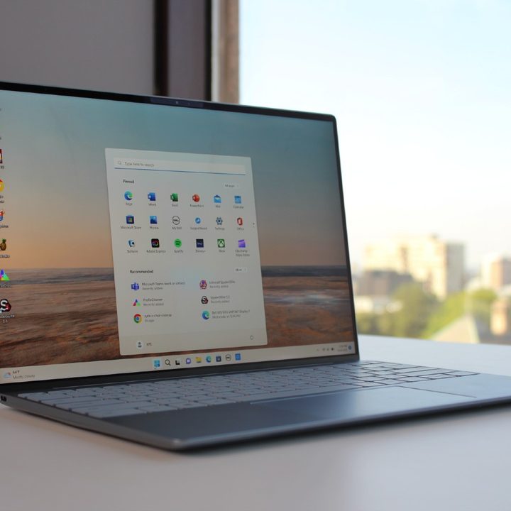 The Dell XPS 13 on a table with the Start Menu open.