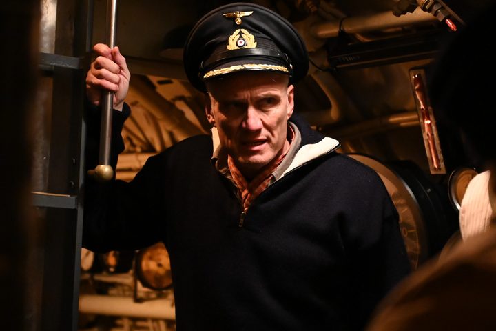 Dolph Lundgren holds onto a pipe inside a U-Boat in a scene from Operation Seawolf.