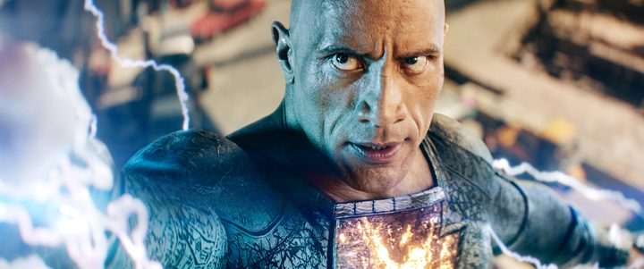 Dwayne Johnson launches lightning from his hand in a scene from Black Adam.