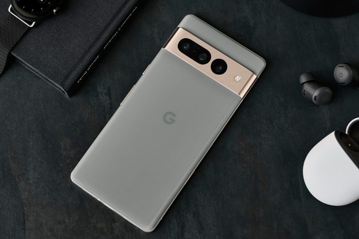 A Google Pixel 7 Pro lying next to a pair of Pixel Buds and the Pixel Watch.