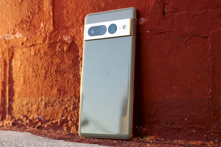 Google Pixel 7 Pro standing up against a red brick wall.