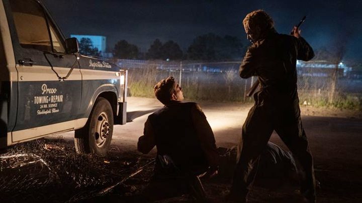 The Shape swings an axe at his male victim in Halloween Ends.