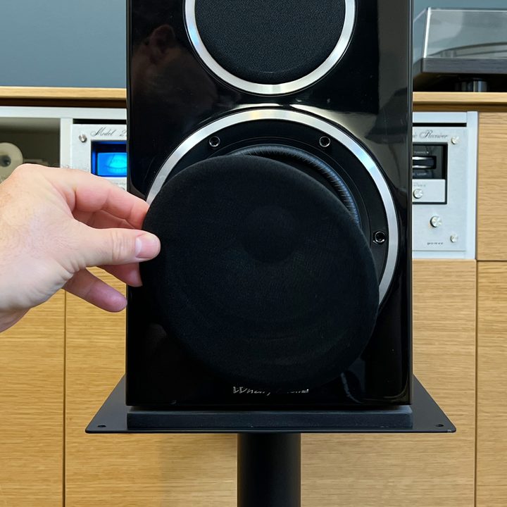 A speaker grill being removed from a speaker.