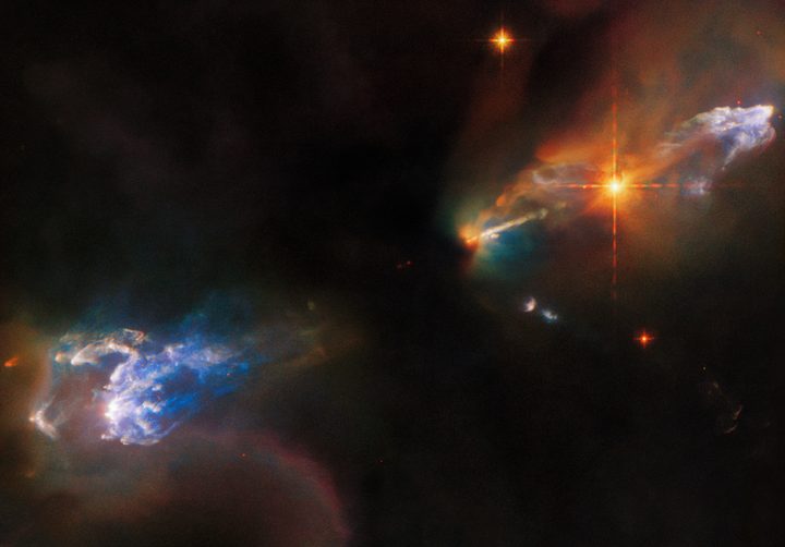 The lives of newborn stars are tempestuous, as this image of the Herbig-Haro objects HH 1 and HH 2 from the NASA/ESA Hubble Space Telescope depicts. Both objects are in the constellation Orion and lie around 1,250 light-years from Earth. HH 1 is the luminous cloud above the bright star in the upper right of this image, and HH 2 is the cloud in the bottom left.
