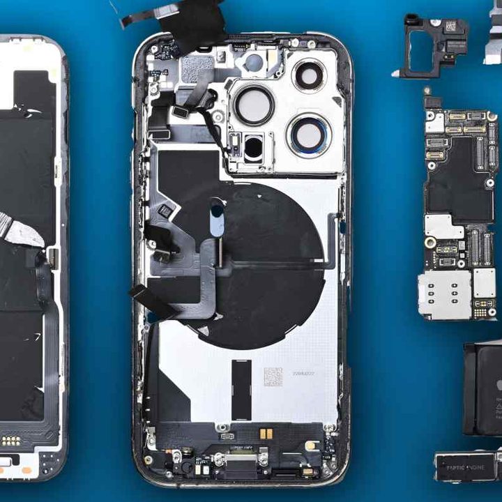 An iPhone 14 pulled apart, revealing all of the components inside.