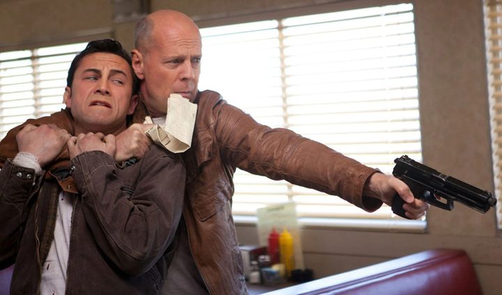 Bruce Willis holds Joseph Gordon-Levitt in Looper.