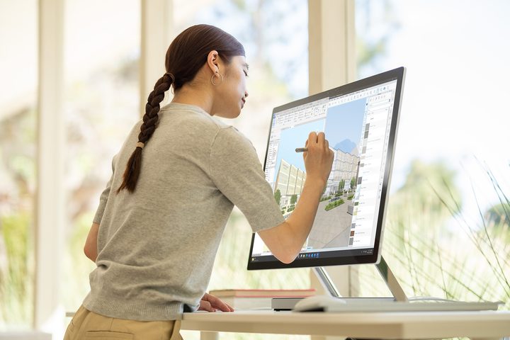 A woman using the Microsoft Surface Studio 2+.