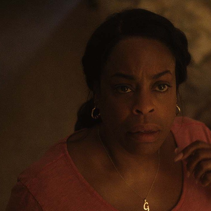 Niecy Nash as Glenda Cleveland looking up at her vent in a scene from Monster: The Jeffrey Dahmer Story.