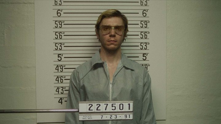 Evan Peters as Jeffrey Dahmer in a mug shot in a scene from Monster: The Jeffrey Dahmer Story.