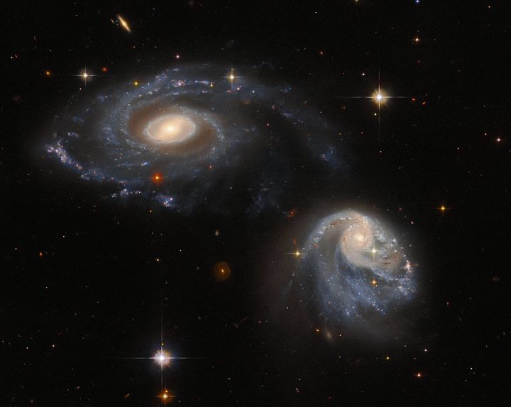 The two interacting galaxies making up the pair known as Arp-Madore 608-333 seem to float side by side in this image from the NASA/ESA Hubble Space Telescope.